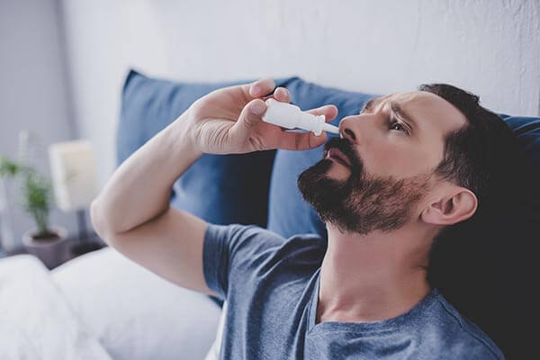 Man Using Nasal Spray